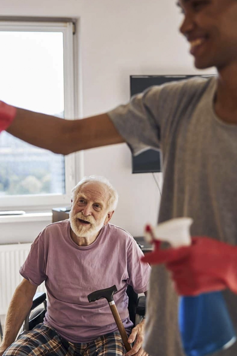 senior man with house hold tasks care worker